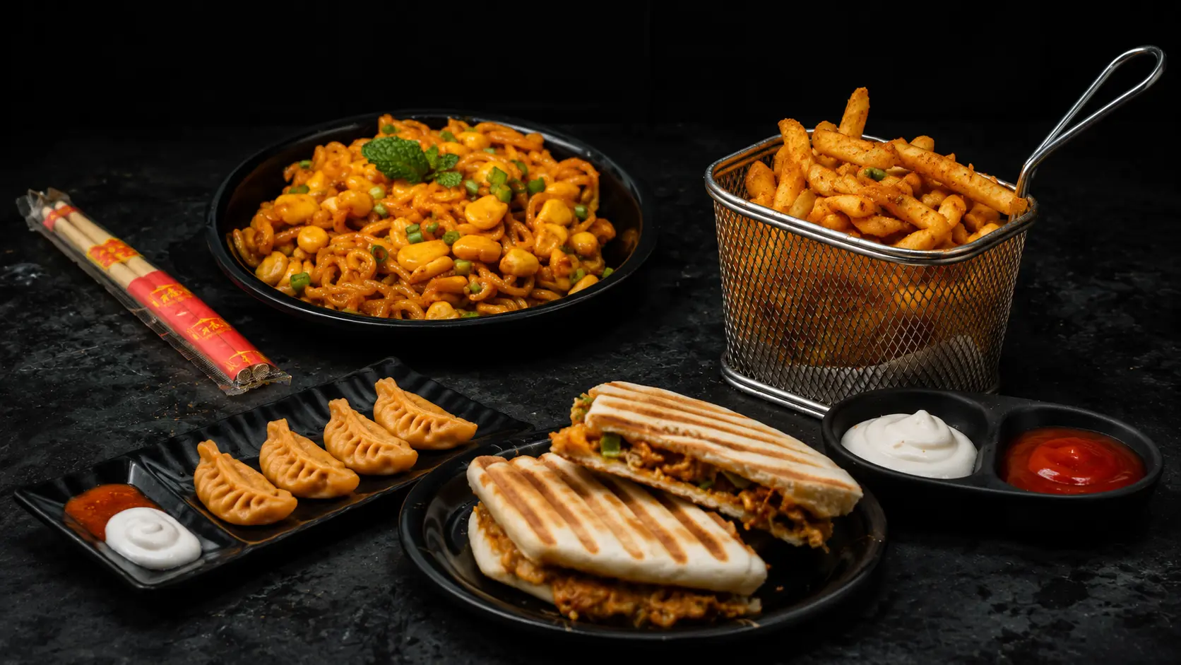 Noodles, masala fries, steamed momos and grilled chicken sandwiches served with dips at Black Bird Cafe & Restaurant, Vellore